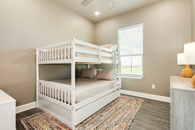 bedroom with ceiling fan and dark hardwood / wood-style floors