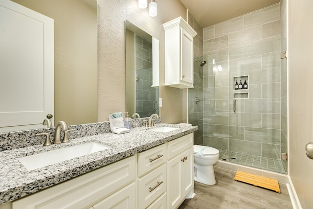 bathroom featuring walk in shower, vanity, toilet, and wood-type flooring