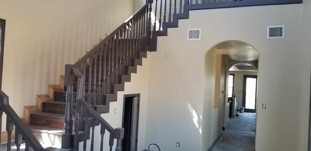 stairs featuring a high ceiling