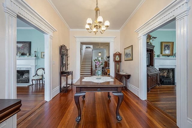 interior space with dark hardwood / wood-style flooring, crown molding, and an inviting chandelier