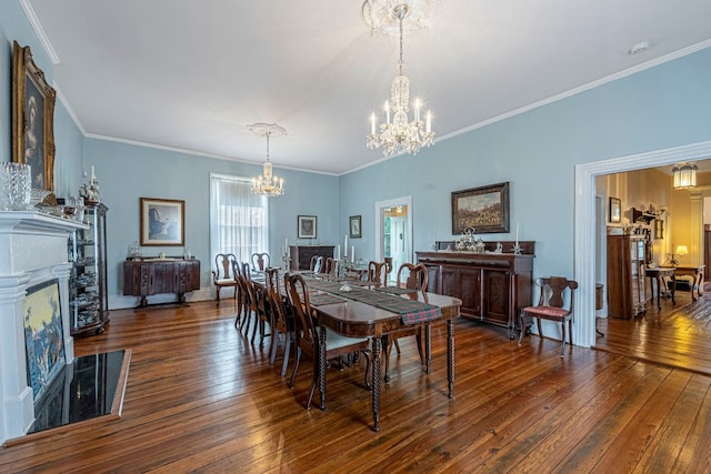 dining area with crown molding, dark hardwood / wood-style floors, and a notable chandelier