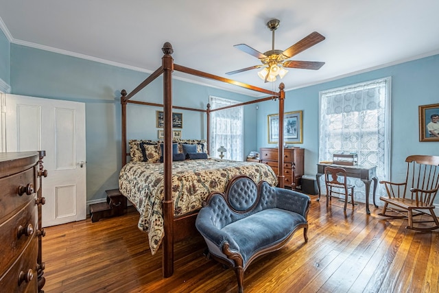 bedroom with ceiling fan, ornamental molding, and dark hardwood / wood-style floors