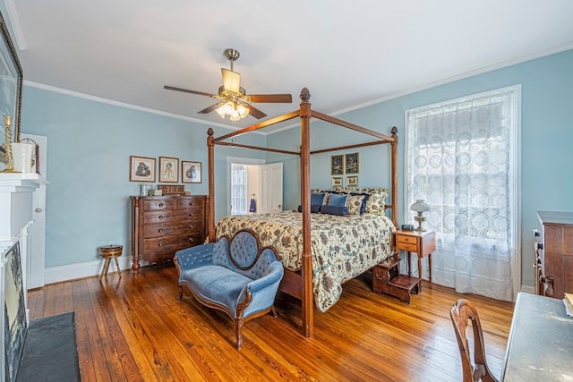 bedroom featuring dark hardwood / wood-style floors, ceiling fan, and ornamental molding