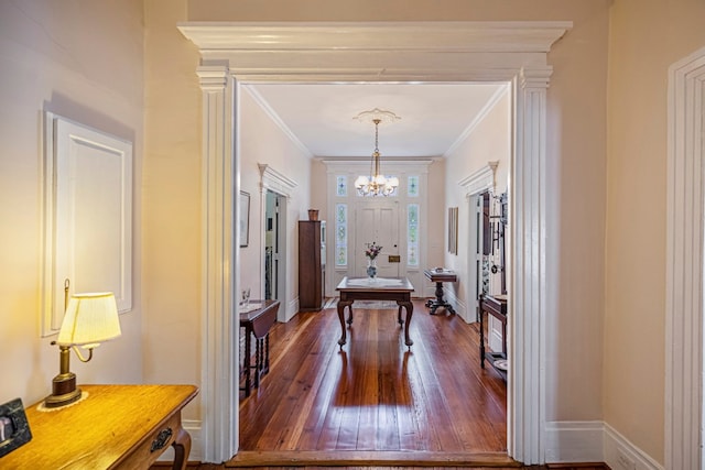 dining room with a chandelier, ornamental molding, and dark hardwood / wood-style floors