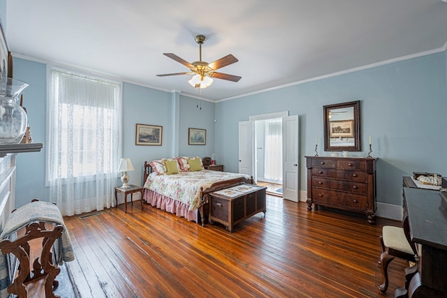 bedroom with crown molding, dark hardwood / wood-style floors, and ceiling fan