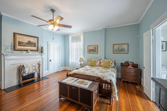 bedroom with crown molding, dark hardwood / wood-style floors, and ceiling fan