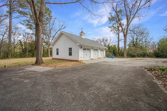 view of side of home featuring a garage