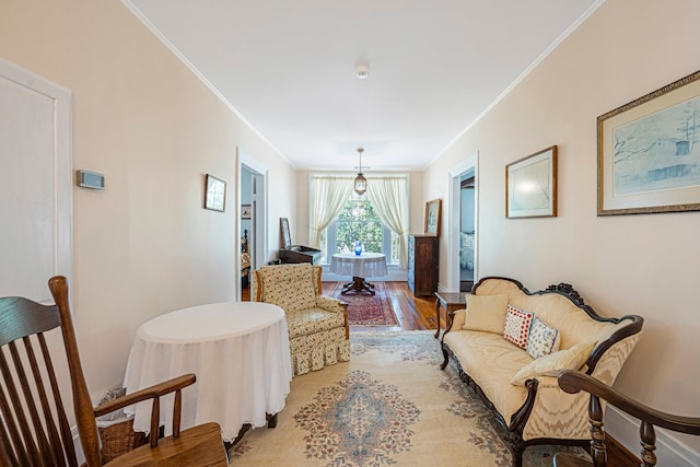 living room with light hardwood / wood-style flooring and crown molding