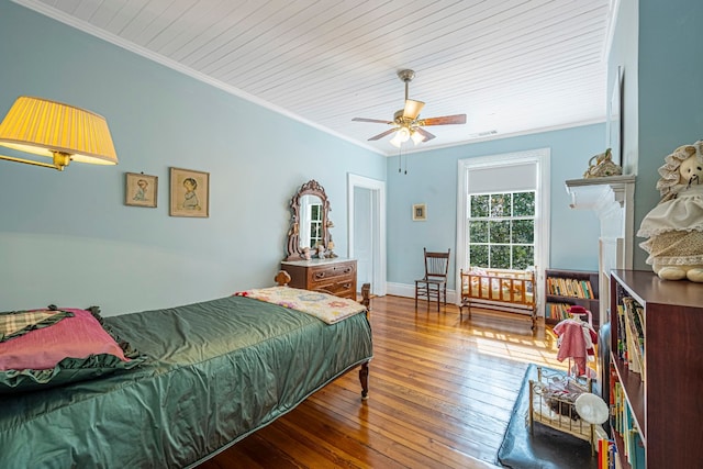 bedroom with ornamental molding, hardwood / wood-style floors, and ceiling fan