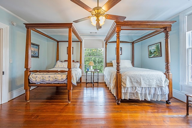 bedroom featuring ornamental molding, ceiling fan, and hardwood / wood-style flooring