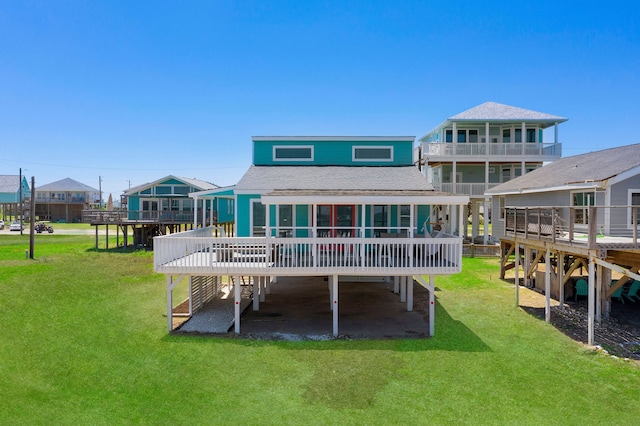 back of house with a lawn and a wooden deck