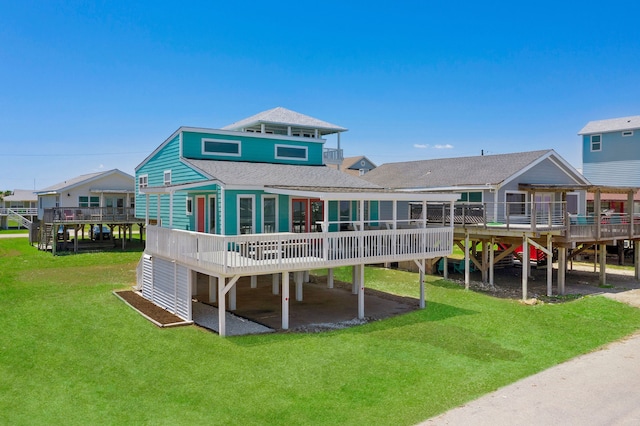 rear view of property with a lawn and a deck