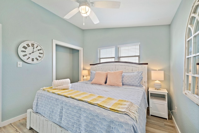 bedroom featuring ceiling fan, vaulted ceiling, and light wood-type flooring