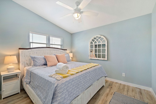 bedroom with lofted ceiling, light hardwood / wood-style floors, and ceiling fan