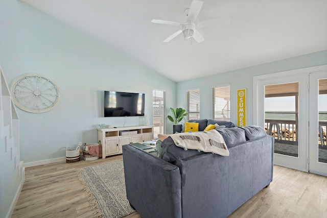 living room with lofted ceiling, ceiling fan, and light wood-type flooring