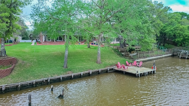 dock area with a water view and a lawn