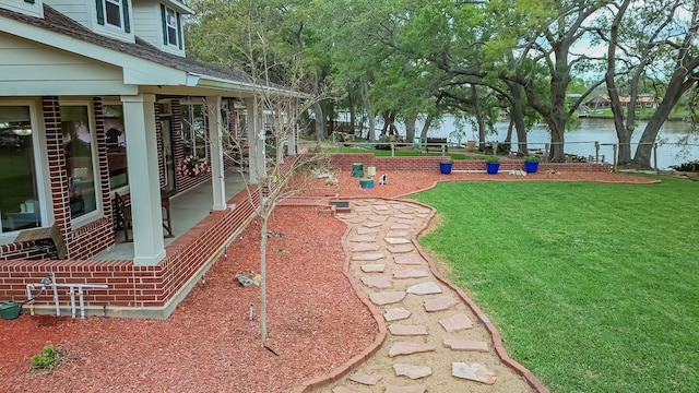 view of property's community with a yard and a water view