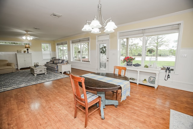 dining room with ornamental molding, light hardwood / wood-style flooring, and ceiling fan with notable chandelier