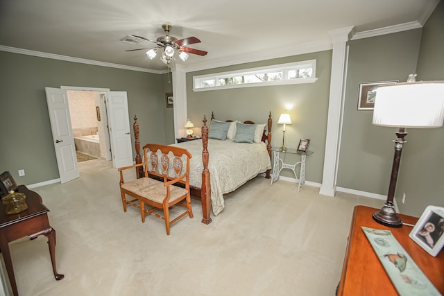 carpeted bedroom featuring ceiling fan, crown molding, ensuite bathroom, and decorative columns