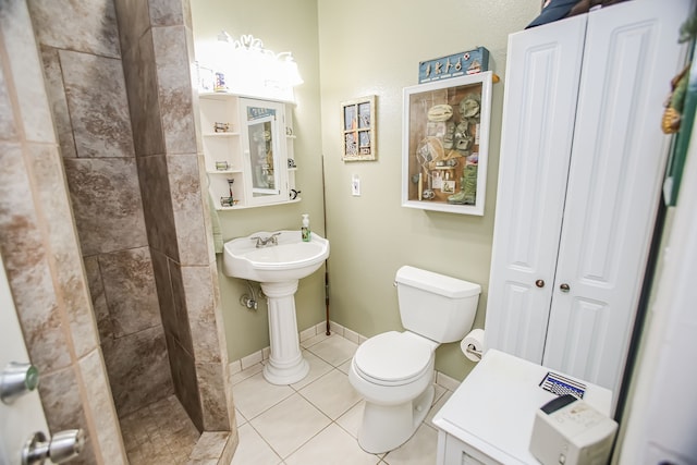 bathroom featuring tile flooring and toilet