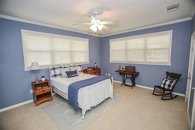 carpeted bedroom with ceiling fan and ornamental molding