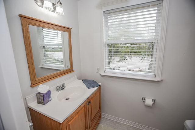 bathroom featuring tile flooring and vanity with extensive cabinet space