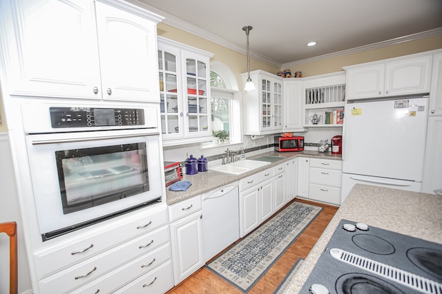 kitchen with sink, appliances with stainless steel finishes, light hardwood / wood-style flooring, tasteful backsplash, and white cabinetry