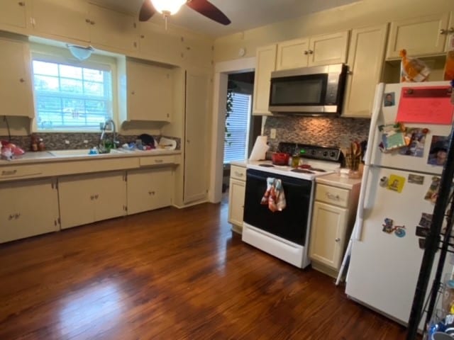 kitchen featuring white appliances, dark hardwood / wood-style floors, and ceiling fan