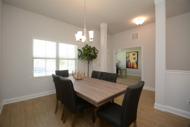 dining room featuring light hardwood / wood-style floors and a chandelier