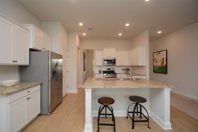 kitchen featuring sink, stainless steel appliances, tasteful backsplash, and white cabinets