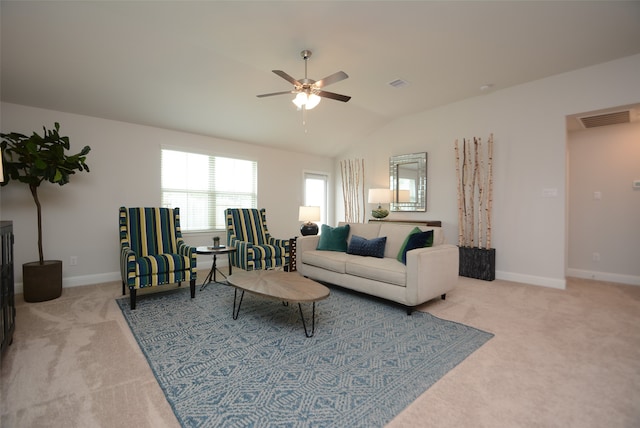 carpeted living room featuring ceiling fan and vaulted ceiling