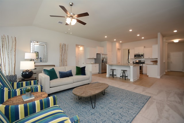 carpeted living room featuring ceiling fan and lofted ceiling