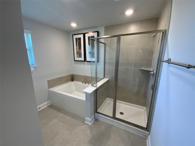 bathroom featuring plus walk in shower and tile floors