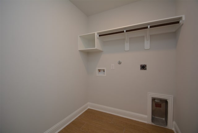 clothes washing area with dark hardwood / wood-style flooring, electric dryer hookup, washer hookup, and gas dryer hookup