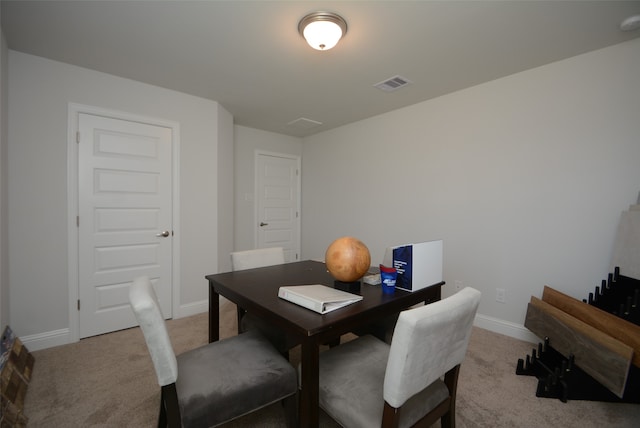 dining room with light colored carpet