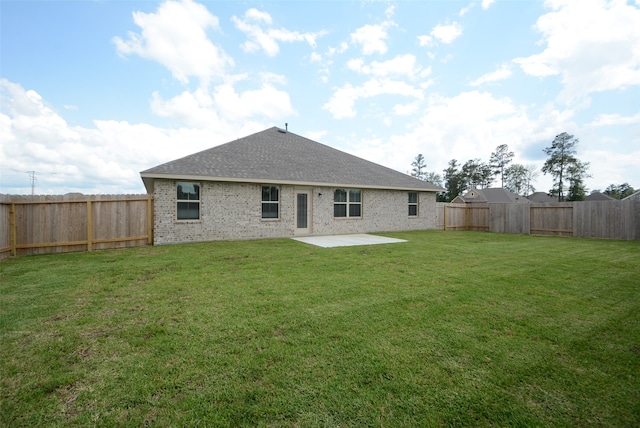 back of property featuring a lawn and a patio area