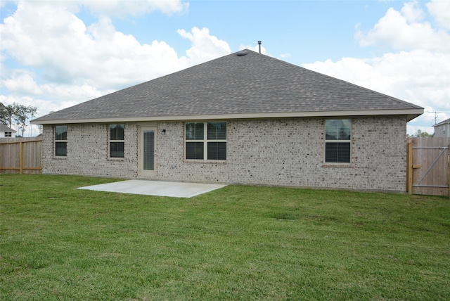 rear view of house featuring a patio and a yard