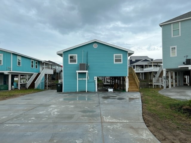 rear view of property featuring a wooden deck