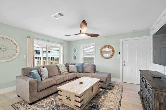 living room featuring ceiling fan and light wood-type flooring