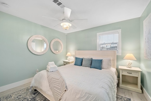 bedroom with ceiling fan and light hardwood / wood-style flooring