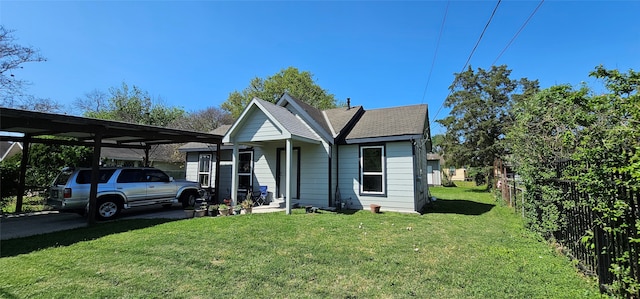 view of front of property with a carport and a front yard