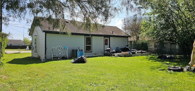 back of house with a lawn