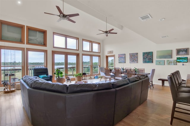 living room featuring ceiling fan, light hardwood / wood-style flooring, high vaulted ceiling, and french doors