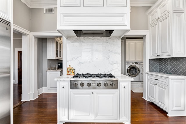 kitchen with white cabinets, dark wood-type flooring, washer / clothes dryer, and gas stovetop