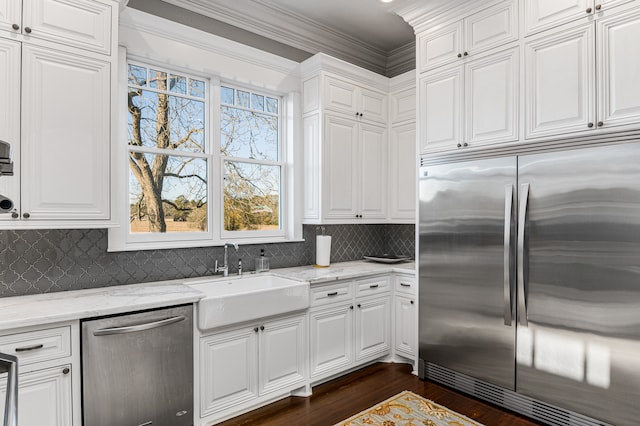 kitchen featuring white cabinetry, appliances with stainless steel finishes, and light stone counters