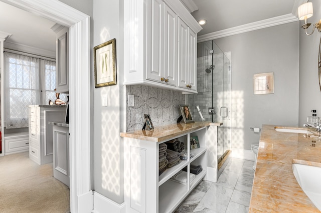 interior space with light colored carpet, sink, crown molding, backsplash, and white cabinetry