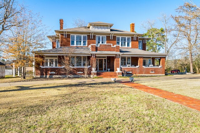 view of front of house featuring covered porch and a front lawn