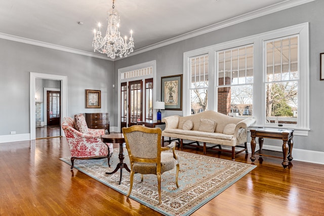 living room with an inviting chandelier, crown molding, and wood-type flooring