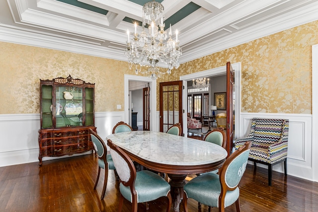 dining space with coffered ceiling, dark wood-type flooring, a notable chandelier, and crown molding