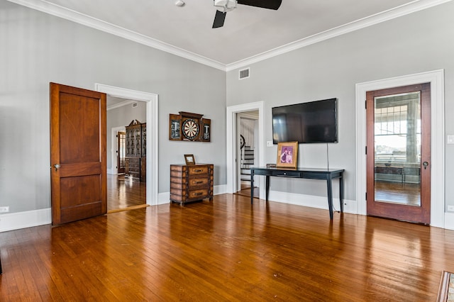 unfurnished living room with dark hardwood / wood-style flooring, ceiling fan, and ornamental molding